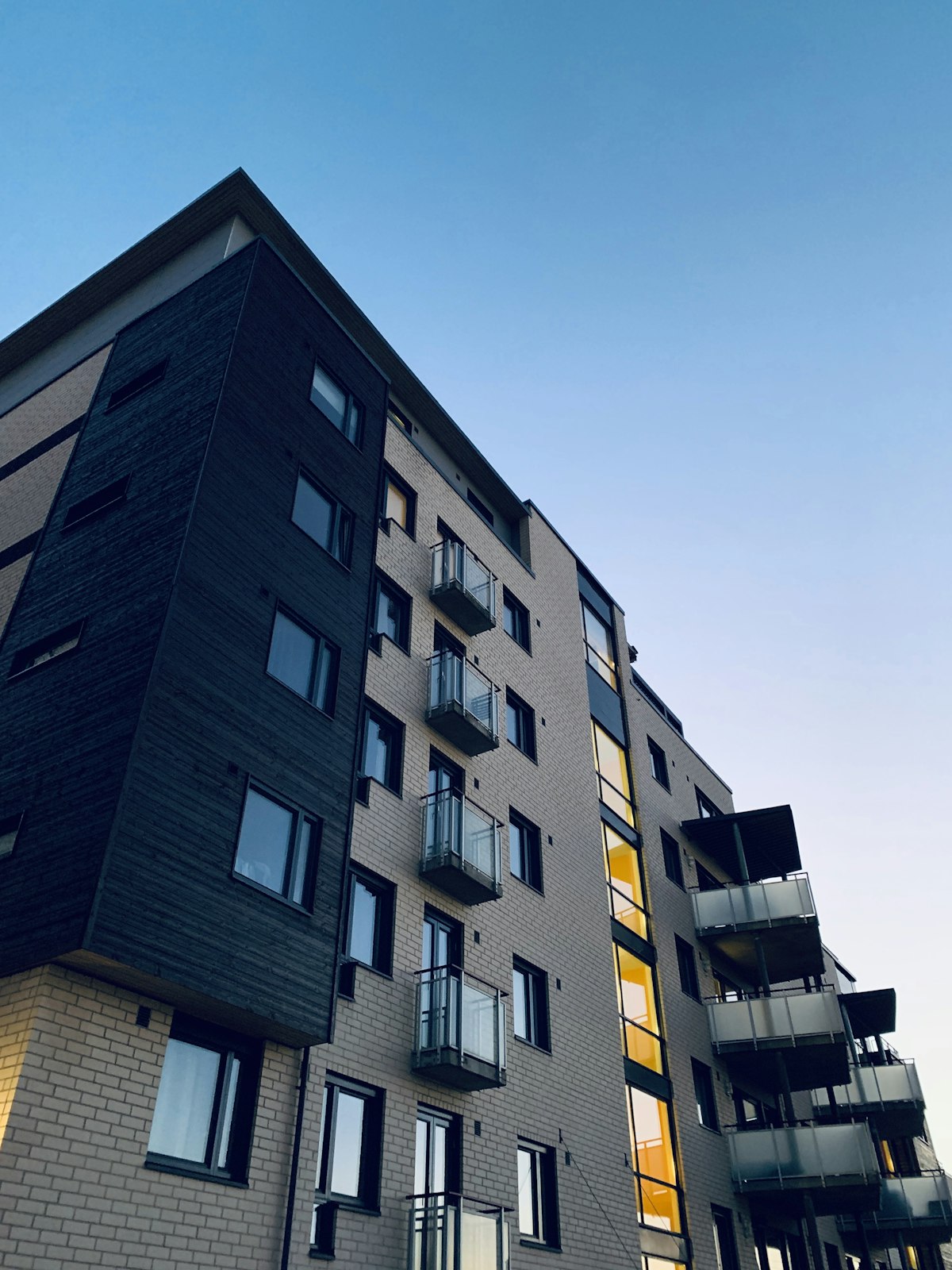 High-rise residential towers with glass curtain walls at twilight