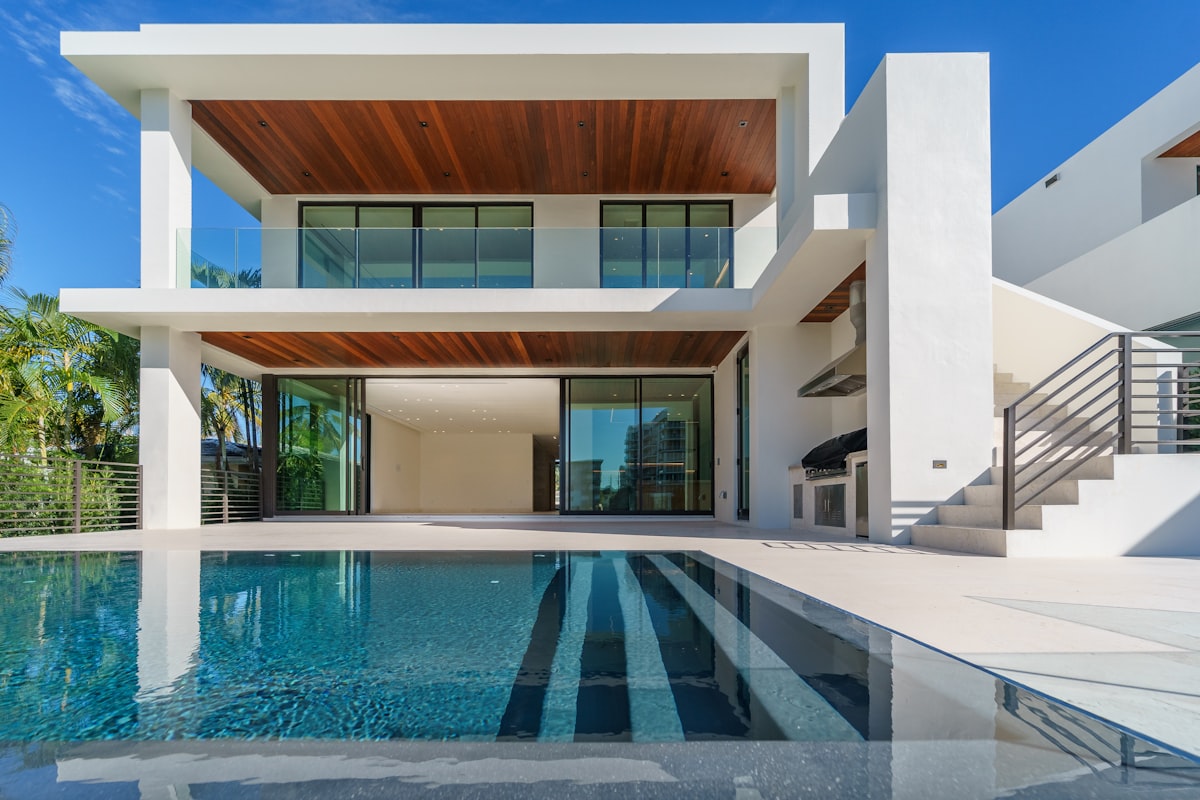 Dramatic modern mansion with infinity pool and glass walls overlooking a valley